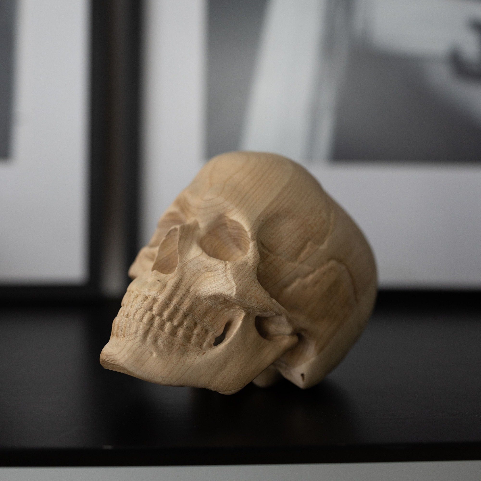 Carved human skull replica from wooden outlet